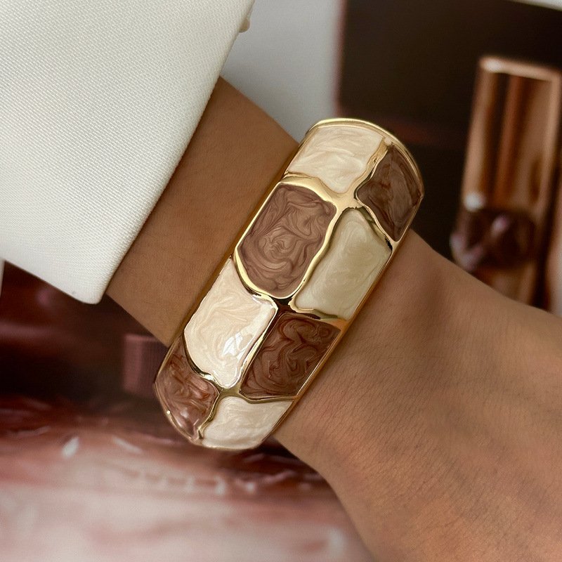 Brown and cream enamel cuff bracelet with gold-tone geometric details