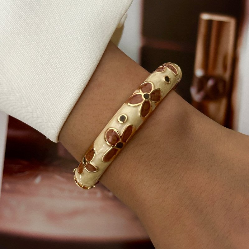Brown and cream enamel cuff bracelet with gold-tone geometric details