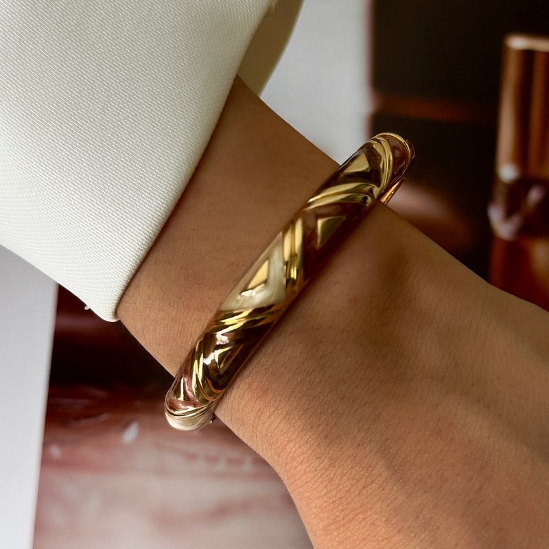 Brown and cream enamel cuff bracelet with gold-tone geometric details