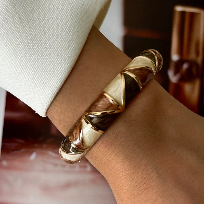 Brown and cream enamel cuff bracelet with gold-tone geometric details