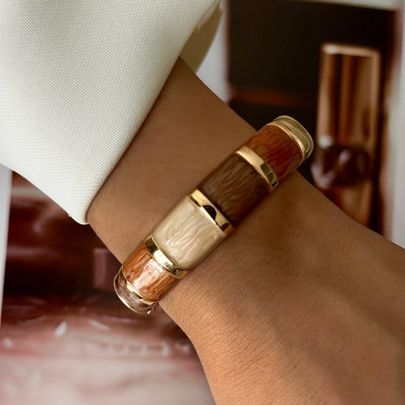 Brown and cream enamel cuff bracelet with gold-tone geometric details