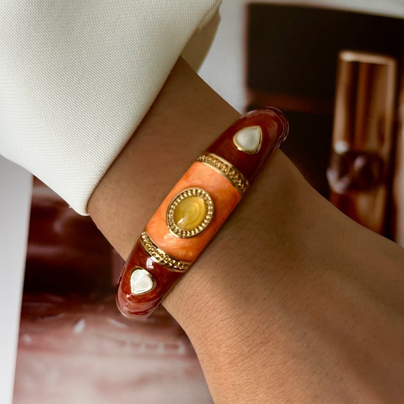 Brown and cream enamel cuff bracelet with gold-tone geometric details