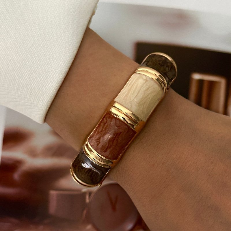 Brown and cream enamel cuff bracelet with gold-tone geometric details