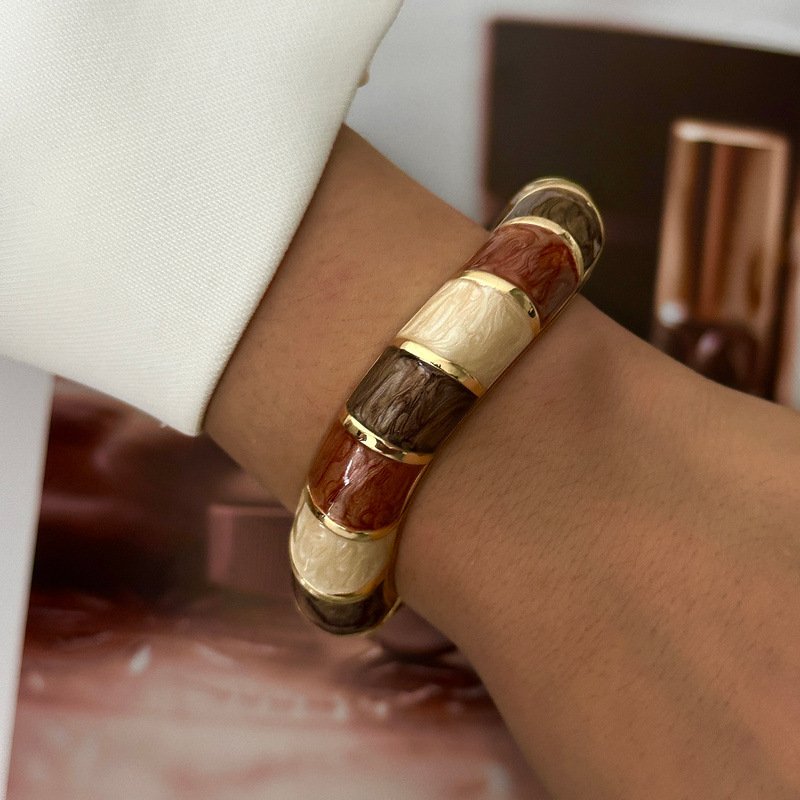 Brown and cream enamel cuff bracelet with gold-tone geometric details