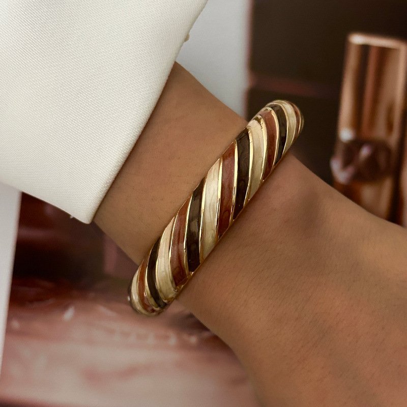 Brown and cream enamel cuff bracelet with gold-tone geometric details