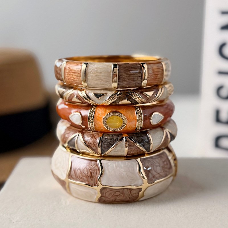 Brown and cream enamel cuff bracelet with gold-tone geometric details